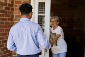 Jackson & Sons employee thanking a customer at their door.