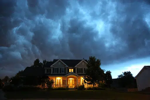 house with storm clouds overhead