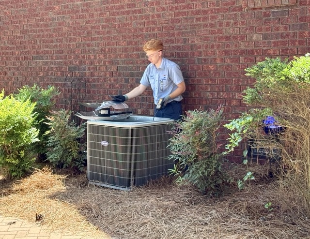Jackson Sons technician working on an Air Conditioning unit in O'Neals Township.