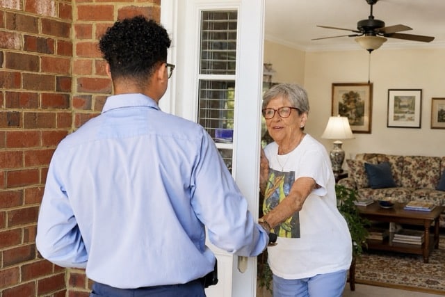 Jackson & Sons employee thanking a customer at their door.