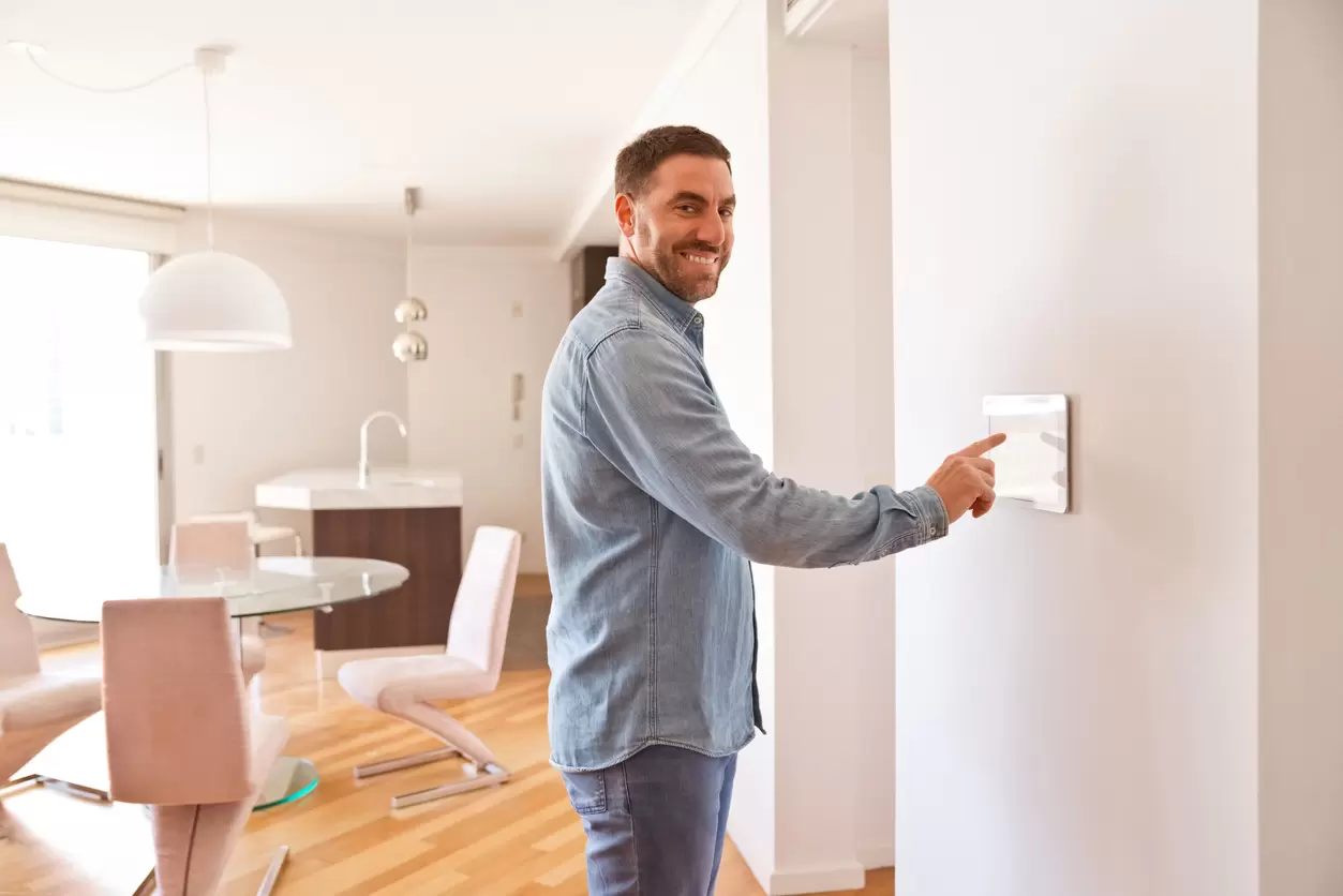 Man activating smart home security system before leaving