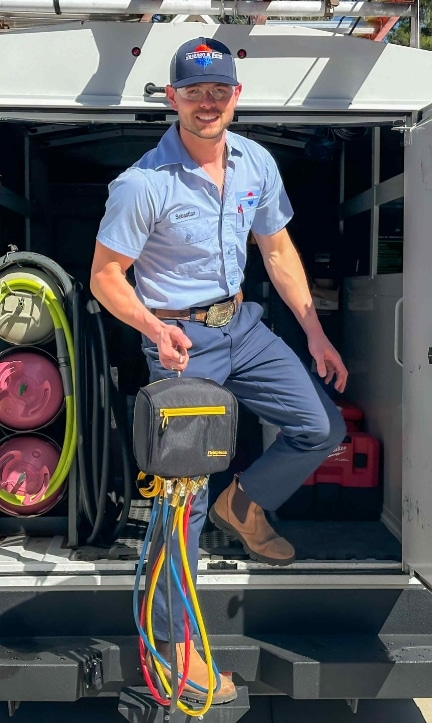 smiling-technician-working-on-hvac-unit